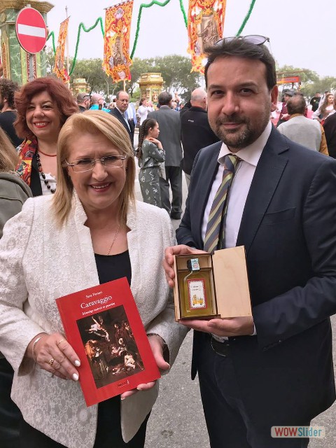 Marie Louise Coleiro Preca, Presidente della Repubblica di Malta, tiene in mano il libro di Sara Favar CARAVAGGIO. con lei Giulio Cusumano, consigliere comunale di Palermo.